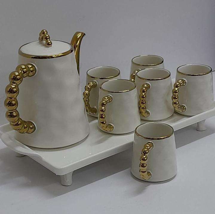 White tea set with golden handles